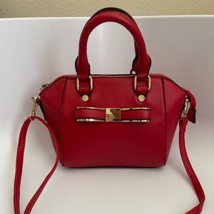 Small red faux leather purse with bow